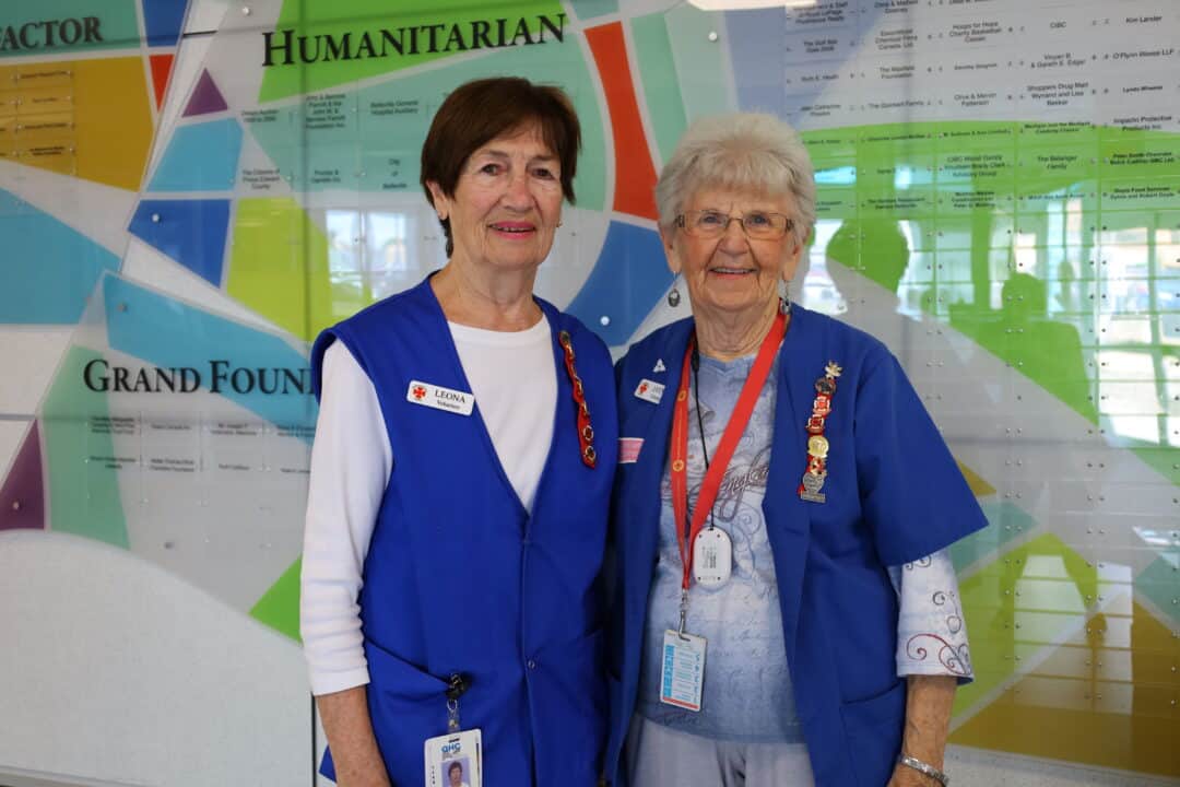 two volunteers, Leona and Jayne, standing close together.