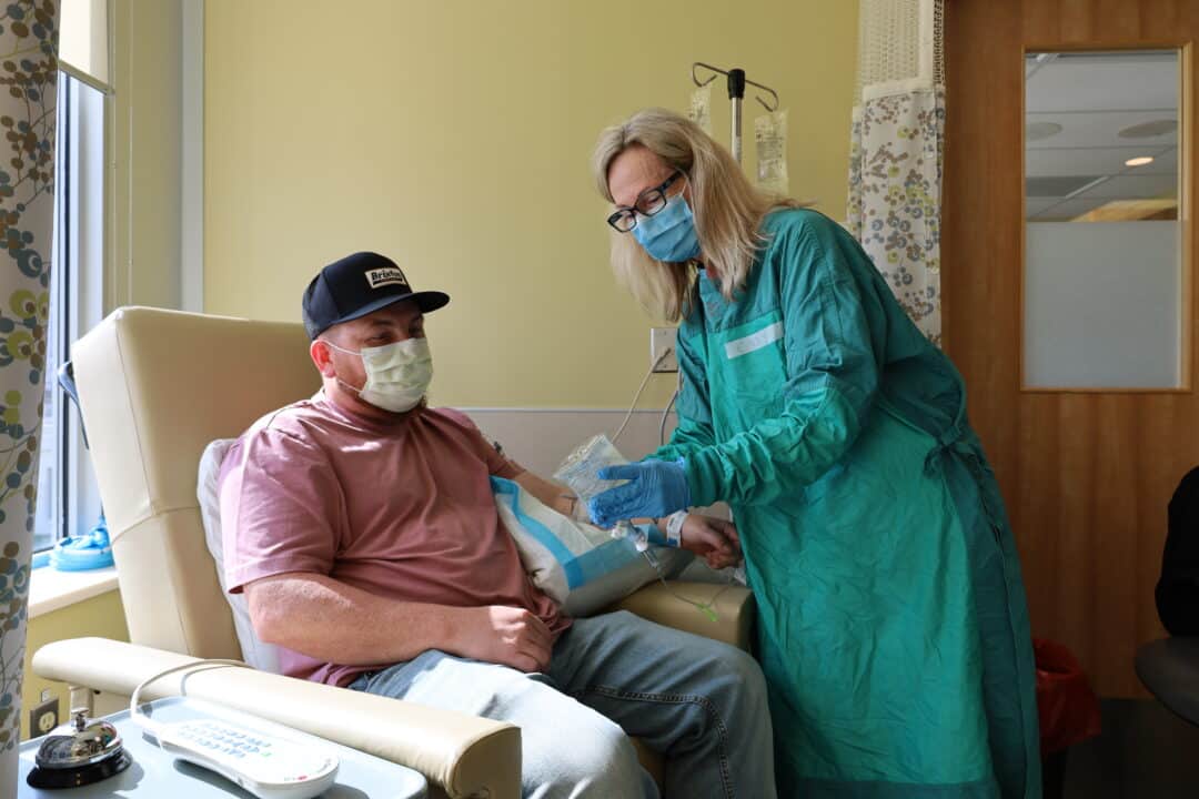 A nurse explaining treatment to a cancer patient.